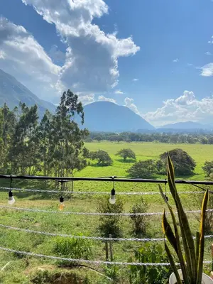 a view of a field with mountains in the background at Cabaña1 con hermosa vista al valle in Oxapampa