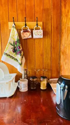 a kitchen counter with utensils on a wooden wall at Cabaña1 con hermosa vista al valle in Oxapampa