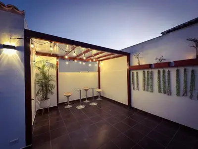 a room with two stools and lights on the wall at Apartamento exclusivo con terraza privada in Lima