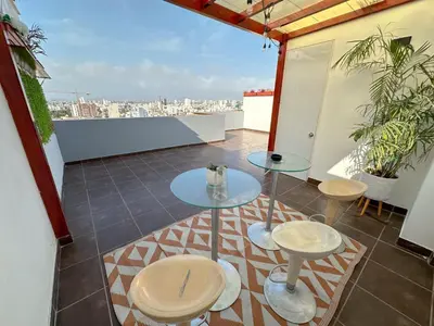 a balcony with two tables and two stools at Apartamento exclusivo con terraza privada in Lima