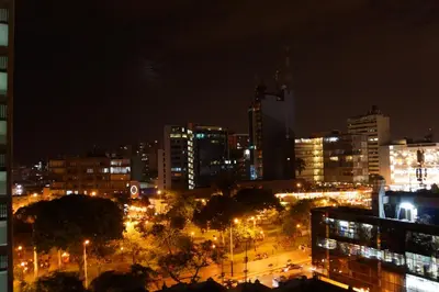 a city lit up at night with lights at Atrium Miraflores Hotel in Lima