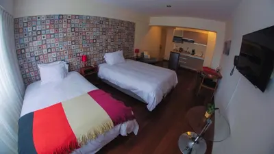 a hotel room with two beds and a television at Atrium Miraflores Hotel in Lima
