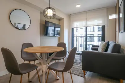 a living room with a table and chairs and a couch at Artline in Barranco by Wynwood House in Lima