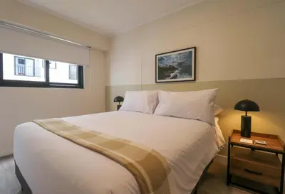 a bedroom with a large white bed and a window at Artline in Barranco by Wynwood House in Lima