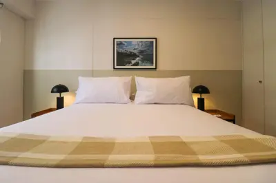 a bedroom with a large white bed with two lamps at Artline in Barranco by Wynwood House in Lima