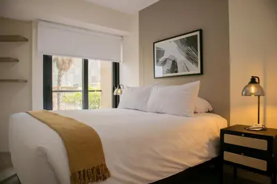 a bedroom with a large white bed with a window at Artline in Barranco by Wynwood House in Lima