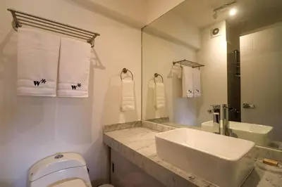 a bathroom with a sink and a toilet and a mirror at Studio 4 by Wynwood House in Lima