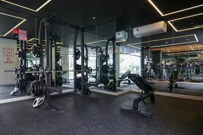 a gym with lots of tread machines and mirrors at Studio 4 by Wynwood House in Lima