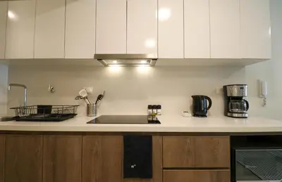 a kitchen with white cabinets and a kitchen sink at Studio 4 by Wynwood House in Lima