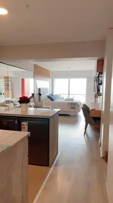 a large kitchen and living room with a couch at Premium Loft-Moderno y Acogedor in Lima