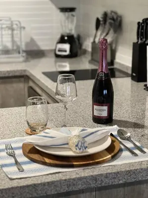 a table with a plate and a bottle of wine at Premium Loft-Moderno y Acogedor in Lima