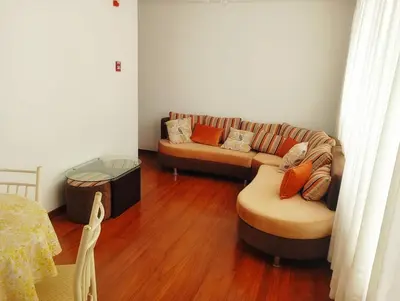 a living room with a couch and a table at Departamento Lima acogedor, ventilado, cálido y moderno San miguel, Lima, Perú in Lima
