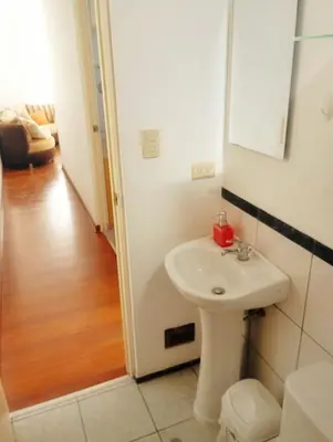 a bathroom with a white sink and a mirror at Departamento Lima acogedor, ventilado, cálido y moderno San miguel, Lima, Perú in Lima