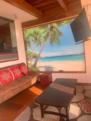 a living room with a large window with a view of the beach at Ali Home in Punta Negra