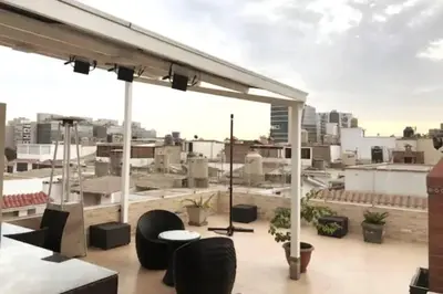 a rooftop patio with a view of a city at Casa de 4 pisos cerca a embajada de USA y centros comerciales in Lima