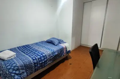 a bedroom with a bed and a glass table at Casa de 4 pisos cerca a embajada de USA y centros comerciales in Lima