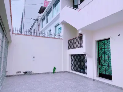 a white building with a green object sitting in the courtyard at P2 Habitación Privada doble Miraflores, LIMA in Lima