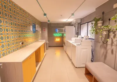 a kitchen with yellow cabinets and a green exit sign at Maravilla en barranco BR1 in Lima