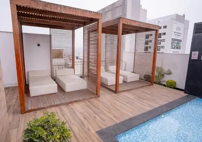 a pergola with two chairs and a pool at Maravilla en barranco BR1 in Lima