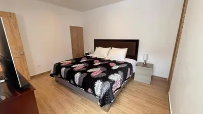 a bedroom with a bed and a television in it at RANCH HAUS OXAPAMPA - PeT FRIENDLY in Oxapampa