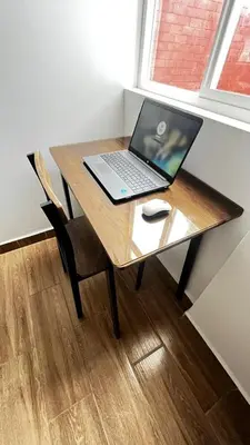 a laptop computer sitting on a wooden table with a mouse at RANCH HAUS OXAPAMPA - PeT FRIENDLY in Oxapampa