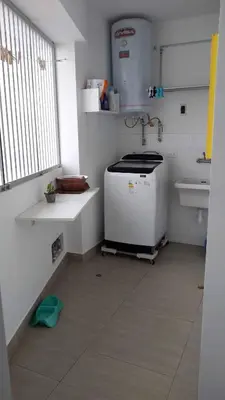 a small kitchen with a sink and a stove at Departamento en PLAYA San Bartolo in San Bartolo
