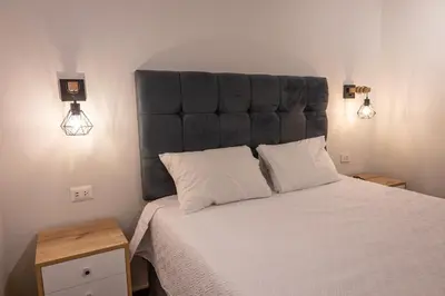 a bedroom with a large bed with a large headboard at Modern loft in front of the boardwalk and the sea in Lima