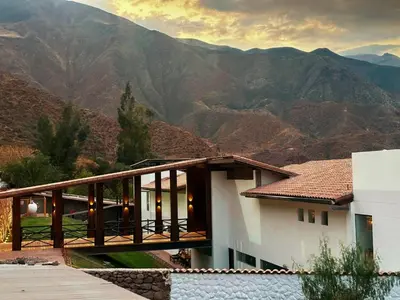 a house with a view of the mountains at RUSTICA HOTELES CUSCO Urubamba in Pachar