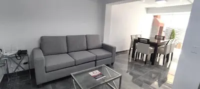 a living room with a couch and a table at El Polo Surco in Lima