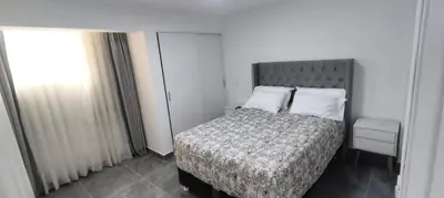 a bedroom with a bed with a blanket and pillows at El Polo Surco in Lima