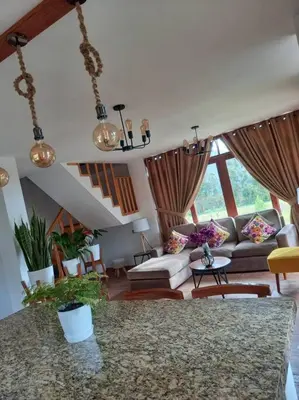 a living room with a couch and a table at Posada de la Sirga Oxapampa De 8 a 10 personas in Oxapampa