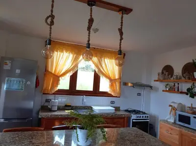 a kitchen with a window and a counter top at Posada de la Sirga Oxapampa De 8 a 10 personas in Oxapampa