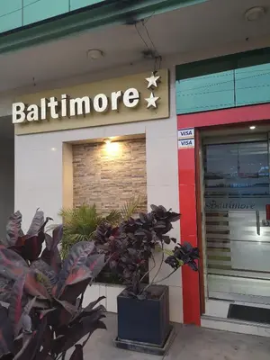 a building with a sign for a restaurant at Hs Baltimore in Lima