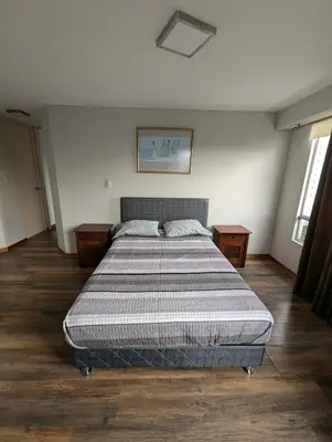 a bedroom with a large bed in a room at Guernica Apartments in Lima