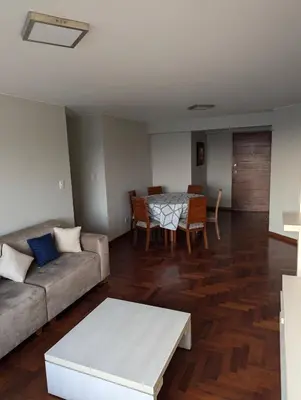 a living room with a couch and a table at Guernica Apartments in Lima