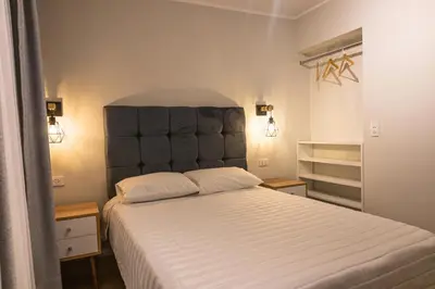 a bedroom with a large bed with a large headboard at Private room by the sea Miraflores in Lima
