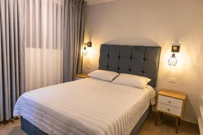 a bedroom with a large bed with a large headboard at Private room by the sea Miraflores in Lima