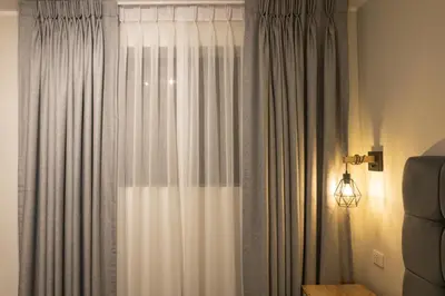 a room with a window with curtains and a lamp at Private room by the sea Miraflores in Lima
