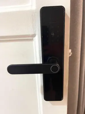 a black door handle with a cell phone on it at Modern Duplex by the sea Miraflores in Lima