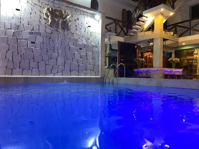 a swimming pool with blue lighting in a hotel at Hostal Ocean Pacifico in Punta Negra