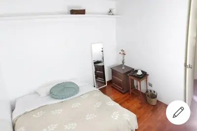 a small bedroom with a bed and a mirror at Departamento jacuzzi Miraflores in Lima