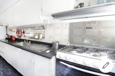 a kitchen with a stove and a sink at Departamento jacuzzi Miraflores in Lima