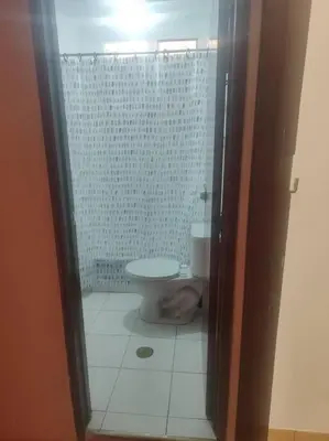 a bathroom with a toilet and a glass shower at Cómoda habitación independiente Miraflores in Lima