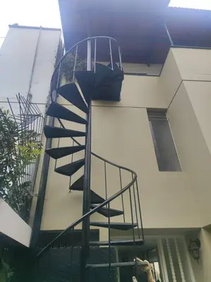 a spiral staircase in the side of a building at Cómoda habitación independiente Miraflores in Lima