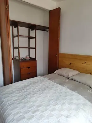 a bedroom with a large bed and a dresser at Cómoda habitación independiente Miraflores in Lima