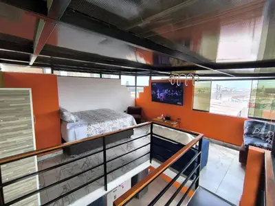 a room with a bed on a balcony at home Blessed III in Lima