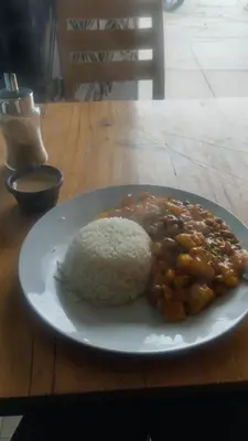 a plate of food with rice and beans on a table at home Blessed III in Lima