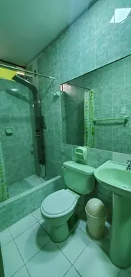 a bathroom with a toilet and a sink and a shower at Hospedaje El Paraiso in Santa Eulalia