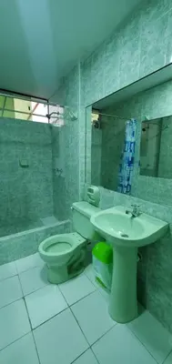 a bathroom with a toilet and a sink at Hospedaje El Paraiso in Santa Eulalia
