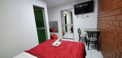 a bedroom with a red bed with a toy on a table at Hospedaje El Paraiso in Santa Eulalia